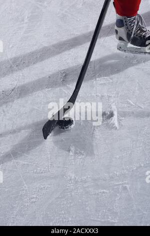 Hockey sticsk e puck su ghiaccio Foto Stock