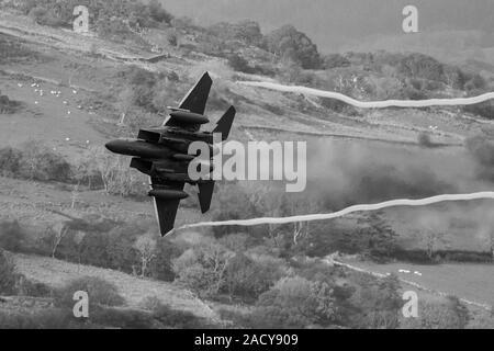 F-15 Eagle, USAF Mc Donnell Douglas caccia a basso livello che vola da Valley Anglesey attraverso il Mach Loop in Cadair Idris Wales Foto Stock