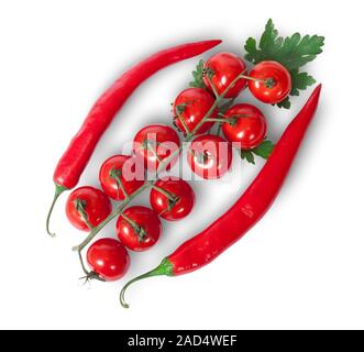 Due peperoncino e pomodori ciliegia sullo stelo con prezzemolo Foto Stock