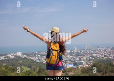 Bruna sta con le braccia alzate Foto Stock