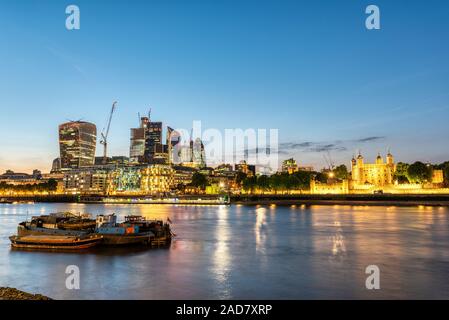 La Torre di Londra ed i grattacieli della città dopo il tramonto Foto Stock