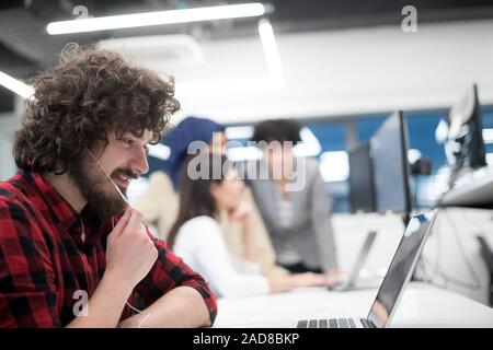 Giovani multiethnics team di sviluppatori di software che lavorano insieme Foto Stock