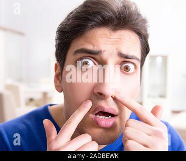 L'uomo nel panico perché di brufoli sulla pelle Foto Stock