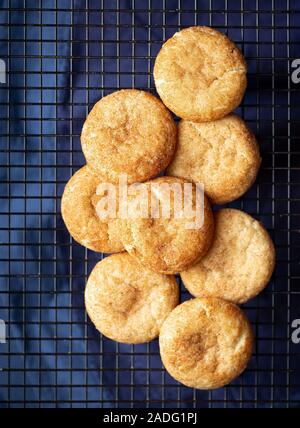 Vista aerea del pane appena sfornato snickderdoodle cookie su una griglia di raffreddamento con un blu scuro biancheria sotto Foto Stock