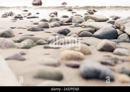 Rocce sulla spiaggia vicino oceano Foto Stock