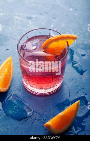 Fresh ice tea summer cocktail con arancia e ghiaccio. Sfondo virati al moderno di colore blu 2020 Foto Stock