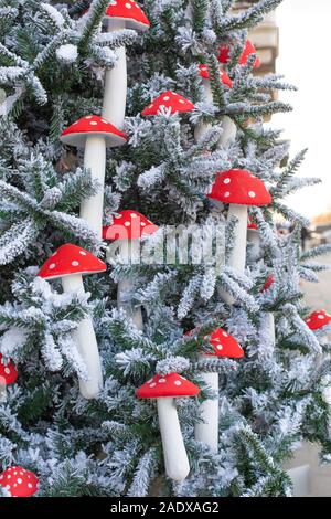 Nuovo Anno di decorazione, verticale. Eco Artificiale di abete e decorazioni in fly agaric. Bellissimo albero di Natale con la neve sui rami e Foto Stock