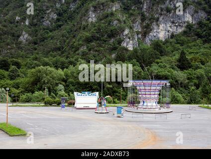 Piccolo parco giostra chiuso giostra in un parcheggio Molto spazio pubblico in un villaggio della Svizzera Foto Stock