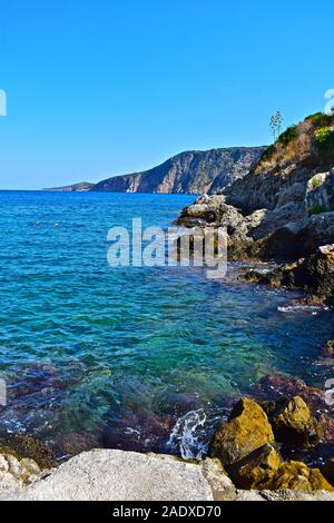 La splendida vista sul mare dal bellissimo villaggio di pescatori di Assos. Crystal clear mare turchese e una costa rocciosa aggiungi alla maestosa scena. Foto Stock