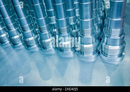 Fondo delle parti in acciaio blu lucido, barre in acciaio lunghe e pulite dopo una tornitura fine a cnc. Foto Stock