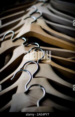 Una fila di coathangers in legno senza vestiti Foto Stock