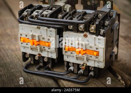 Close-up di un usato motorino di avviamento elettrico (magnetico motorino di avviamento). Un dispositivo elettromagnetico per gradualmente iniziando ad alta potenza motori elettrici. Vista laterale. Foto Stock