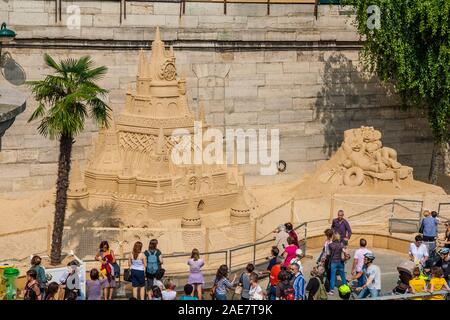 Persone ammirando la grande scultura di sabbia di un castello con Topolino e Minnie Mouse a Quai du Louvre durante il popolare Paris Plage giorni su una bella... Foto Stock