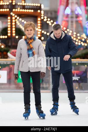 SNP leader Nicola Storione pattini da ghiaccio durante una visita alla Aberdeen Mercatino di Natale nel quad, Marischal College, sulla campagna elettorale trail. Foto Stock