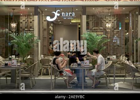 Thailandia ristorante esterno con i clienti al di fuori del pranzo e la cameriera che serve. Thailandia del sud-est asiatico Foto Stock