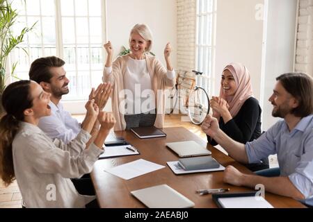 Happy team leader per celebrare il successo aziendale con i colleghi. Foto Stock