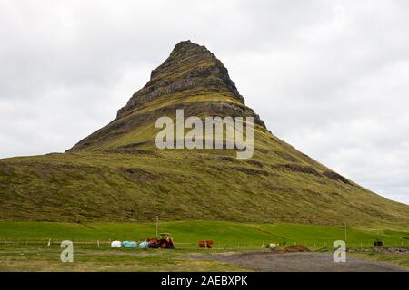 La forma strana montagna Kirkjufell è 463m di altezza e si trova vicino al villaggio di Grundarfjoerdur, Islanda. Foto Stock
