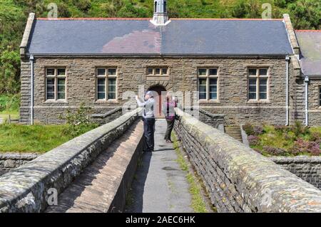 Elan Valle del Centro Visitatori Rhayader, Powys Galles 06 Agosto 2012: Padre e figlia cercando in direzioni opposte al Caban Coch Dam Casa della pompa Foto Stock