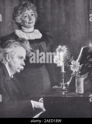 Edvard Grieg suonare il pianoforte con sua moglie Nina stare a guardare. Foto Stock