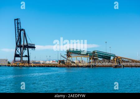Pier gru e il caricamento di massa di servizi di trasporto di una produzione di acciaio e rottami metallici Riciclaggio Schnitzer Steel Industries Company presso il porto di O Foto Stock