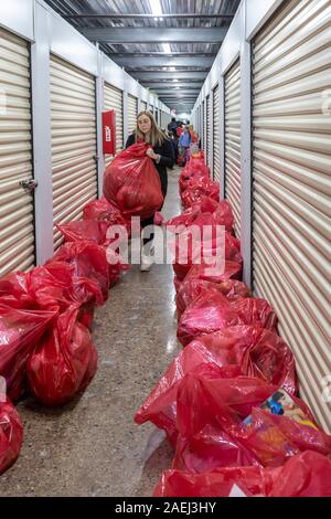 Madison Heights, Michigan - Volontari da ebrei, cristiani e musulmani di organizzazioni e di ordinamento pack donato regali di Natale per i bambini svantaggiati Foto Stock