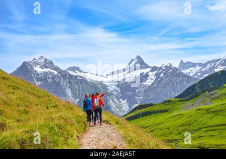 Grindelwald, Svizzera - Agosto 16, 2019: estate paesaggio alpino. Gli escursionisti femmina e alpi svizzere in background. Fotografato sul sentiero da Grindelwald a Bachalpsee. Foto Stock