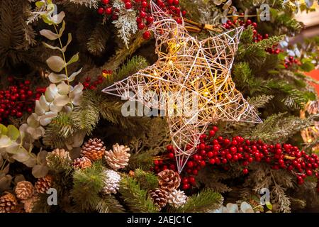 Le decorazioni di Natale con una grande stella appesa dai rami di abete Foto Stock