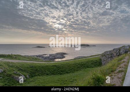 Paesaggio con isola e scogliere sotto alto cielo nuvoloso, shot al tramonto sotto la luminosa luce estiva vicino Bleik, Andoya, Vesteralen, Norvegia Foto Stock