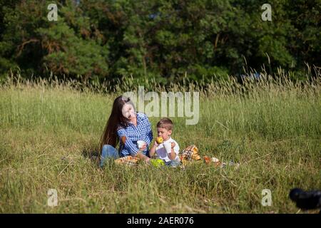 Bella la mamma con suo figlio in un picnic a riposo nella natura Foto Stock