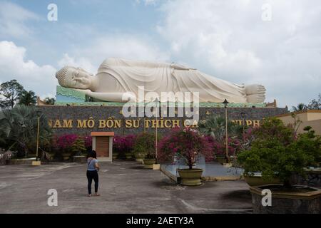 Una gigantesca statua di un sdraiato Buddha a Vinh Trang pagoda nel Vietnam del sud nei pressi di My Tho Foto Stock