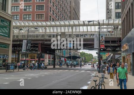 Chicago, Illinois, Stati Uniti d'America - Circa 2019: vista del centro della città di angolo di strada intersezione durante il mattino Rush Hour loop di commutare il treno passa sul binario di overhead Foto Stock