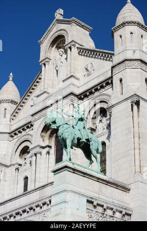 Giovanna d Arco statua equestre in bronzo sulla facciata della basilica del Sacre Coeur, con il calcare architettura della chiesa al di là di Foto Stock