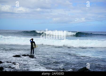 Surfer portante della tavola da surf. Guardando al mare. Andare a fare surf. Foto Stock
