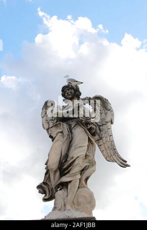 Angelo Che Porta la Corona Di Spine di Gian Lorenzo Bernini e un teschio si ergono sulla statua superiore di Castel Sant'Angelo, Roma, Italia Foto Stock