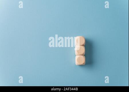 Vuoto tre dadi di legno impilate su fondo azzurro. Con abbondanza di spazio di copia. Foto Stock