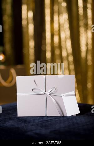 Un bel regalo Buste pastello in toni di grigio con un biglietto di auguri. Anno nuovo e di Natale Foto Stock