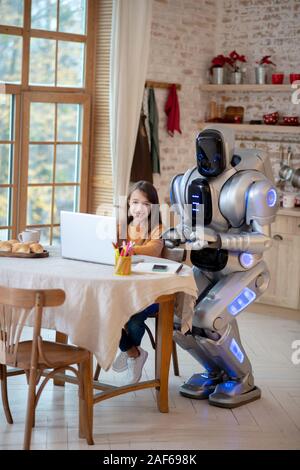 Ragazza dai capelli scuri facendo il suo lezioni di cucina Foto Stock