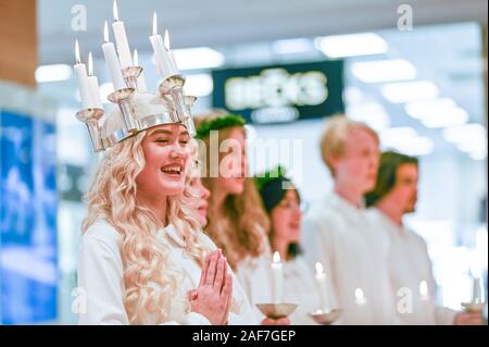 Tradizionale festa di Santa Lucia in Svezia. Norrkoping's Lucia 2019 Izabella Swartz cantando canti natalizi nel centro commerciale di Linden. Foto Stock