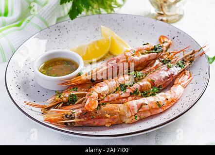 Alla griglia argentina selvatico gamberi rossi/di gamberi con prezzemolo e aglio olio e limone. Il cibo è delizioso. Cheto / Paleo dieta. Foto Stock