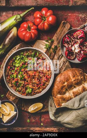 Bagno Turco e Medio Oriente meze tradizionale motorino di avviamento. Piatto di laici Babaganoush immersione a freddo condito con prezzemolo e i semi di melograno con flatbread oltre rus Foto Stock