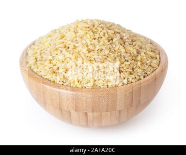 Non cotti bulgur in ciotola di legno isolato su sfondo bianco con tracciato di ritaglio Foto Stock