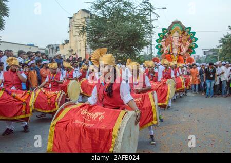 AMRAVATI, Maharashtra, India - 27 settembre 2018: folla di persone non identificate che porta dio indù Ganesha per immersione con tamburi e musica ad acqua Foto Stock