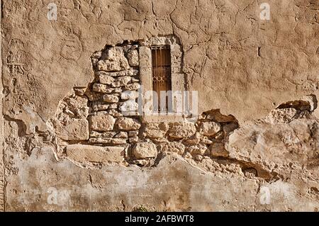 Scena di sfondo che mostra le pietre dietro una parete in stucco su una strada stretta in Saint Remy de Provence. Foto Stock