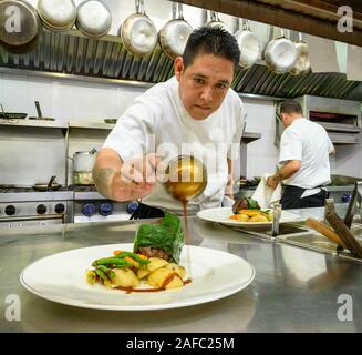 Ristorante Iguana cook Javier Marias versando il Cile in salsa di un filetto di angus entree a Casa Kimberly, Puerto Vallarta, Jalisco, Messico. Foto Stock