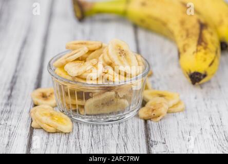 Banane essiccate chip su un sfondo vintage come dettagliato di close-up shot, il fuoco selettivo Foto Stock