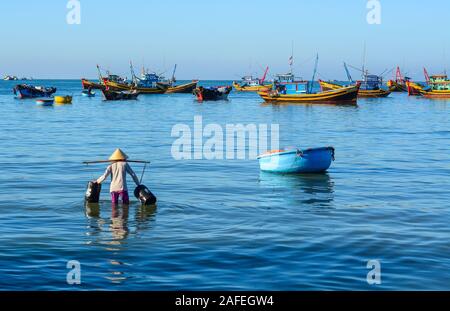 Phan Thiet, Vietnam - Mar 19, 2016. Le donne con i tradizionali cappelli lavora al villaggio di pescatori di Phan Thiet, Vietnam. Foto Stock