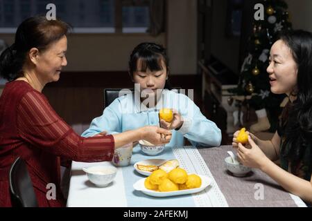 (191215) -- MACAO, Dic 15, 2019 (Xinhua) -- Yu nel peccato (C) presenta la prima colazione con la sua madre e nonna di Macao, Cina del sud, nov. 25, 2019. Il 10-anno-vecchio Yu, nato a Macao, è un quinto grado di studente della Scuola di Premier affiliate a Hou Kong scuola media. Suo fratello anche gli studi presso la scuola. Agli occhi di sua madre, Yu nel peccato è un ottimista, soleggiata e vivace ragazza con molti talenti. Ha vinto molti premi in Macao studenti della scuola primaria' storytelling, recita, arte e competizioni di ballo. Sebbene nato dopo Macao il suo ritorno alla Cina, Yu imparato molto circa la patria ho Foto Stock