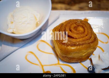 Sticky bun con gelato alla vaniglia Foto Stock