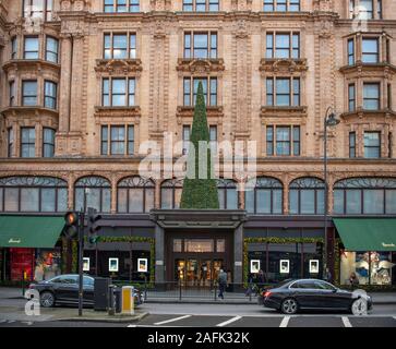 Knightsbridge di Londra, Regno Unito. 16 dicembre 2019. Albero di natale sopra la tettoia di ingresso ai magazzini Harrods in Brompton Road a Londra. Credito: Malcolm Park/Alamy. Foto Stock