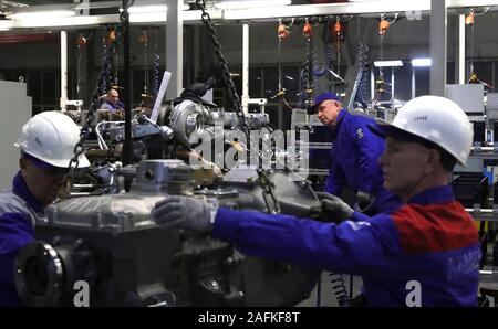 Linea di assemblaggio i lavoratori lavorano su carrello motori come il Presidente russo Vladimir Putin tours la Daimler KAMAZ Rus il motore e il telaio del carrello di joint venture veicolo commerciale impianto Dicembre 13, 2019 in Naberezhnye Chelny, il Tatarstan, Russia. Foto Stock